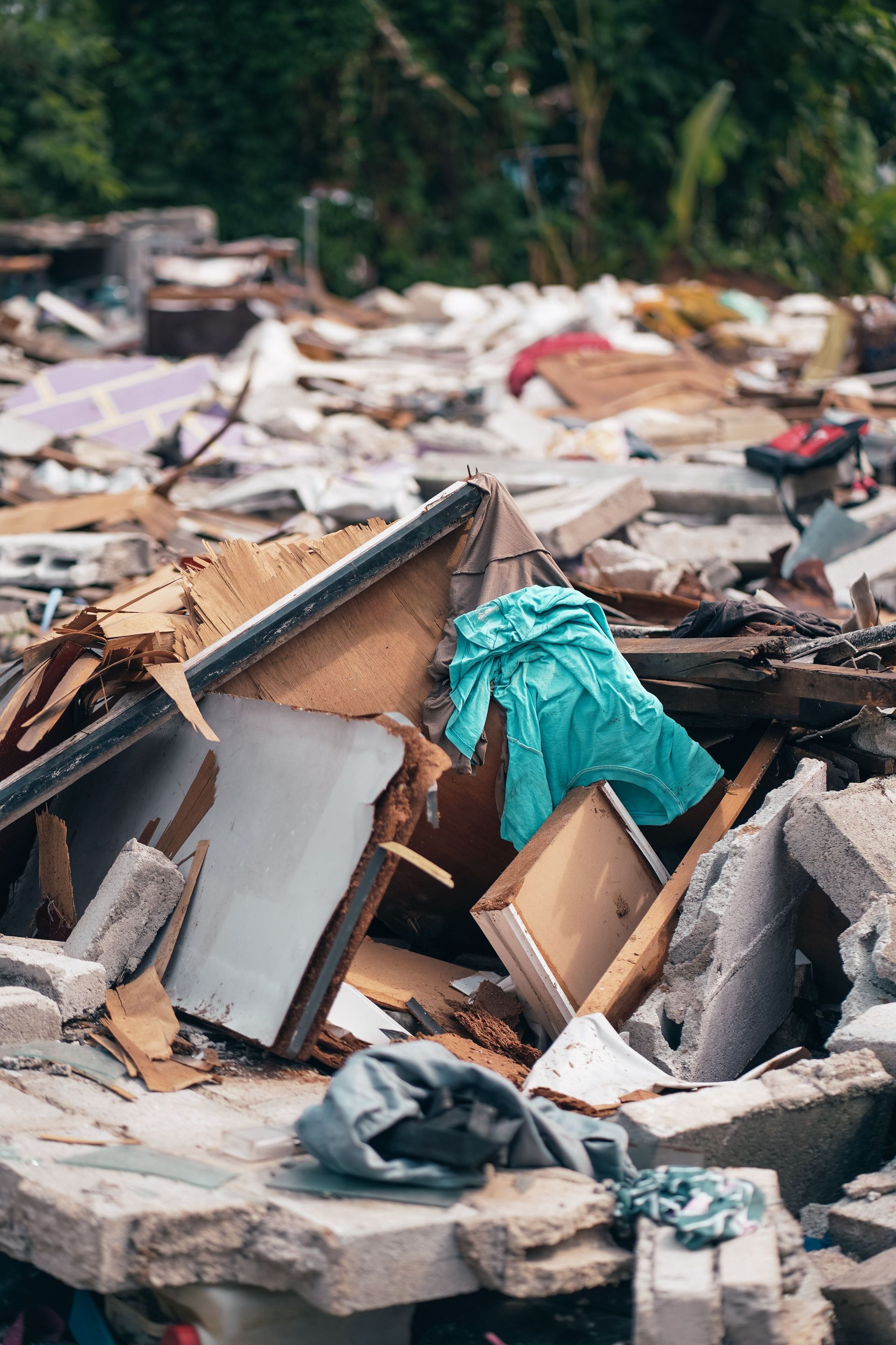 Piles of construction rubble and debris in an outdoor urban junkyard in Selangor, Malaysia.