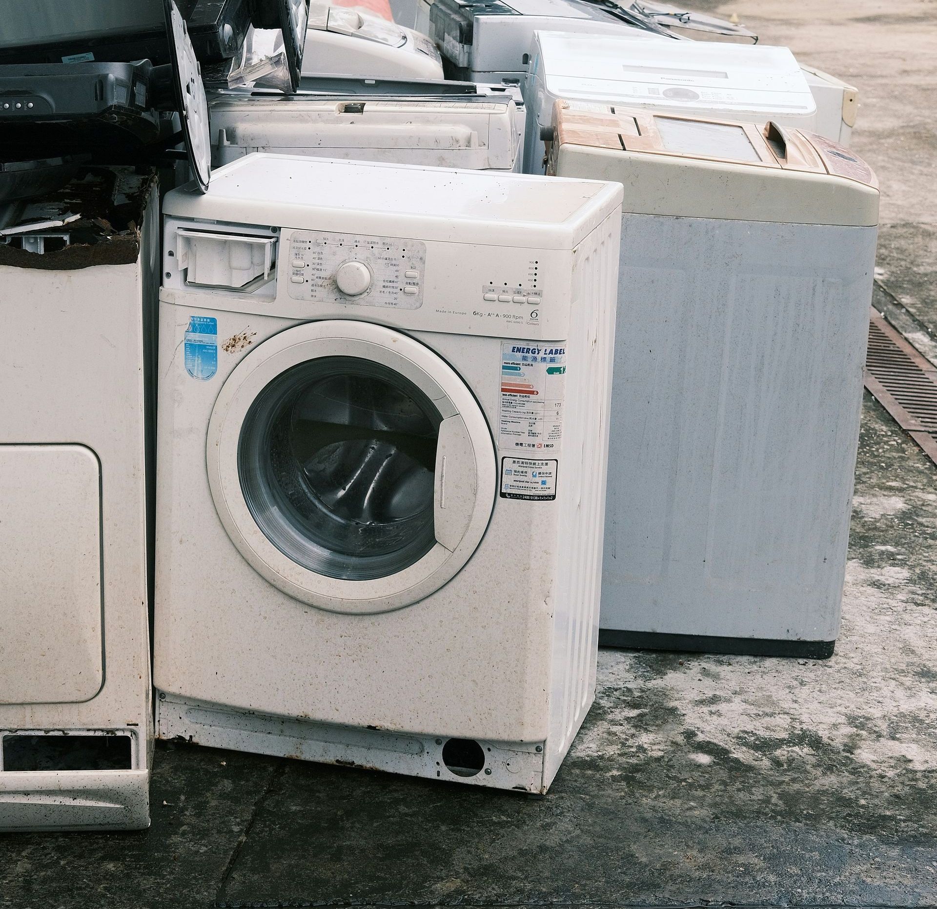 a pile of washing machines sitting next to each other